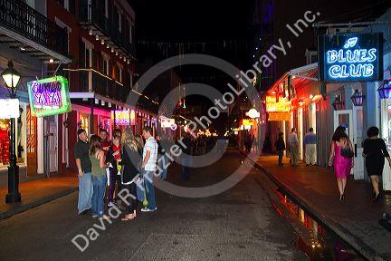 Neon signs of bars and restaurants along Bourbon Street in the French Quarter of New Orleans, Louisiana, USA.