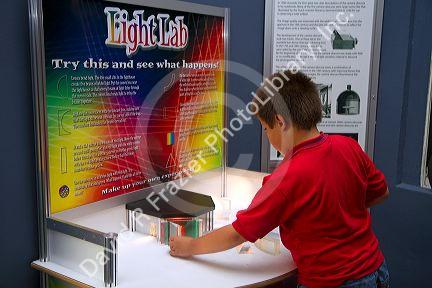 Boy using an interactive exhibit at the Gulf Coast Exploreum Science Center in Mobile, Alabama, USA.