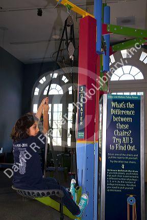 Girl using an interactive exhibit at the Gulf Coast Exploreum Science Center in Mobile, Alabama, USA.
