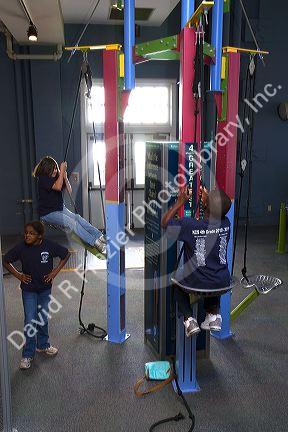 Children using an interactive exhibit at the Gulf Coast Exploreum Science Center in Mobile, Alabama, USA.