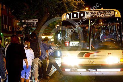 People boarding a public transportation bus in Buenos Aires, Argentina.