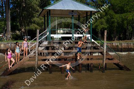 Children jumping into the Parana Delta at Tigre, Argentina.
