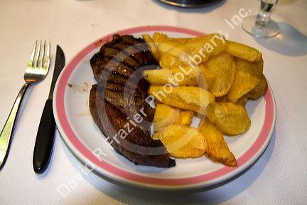 Meal of steak and fries in Buenos Aires, Argentina.
