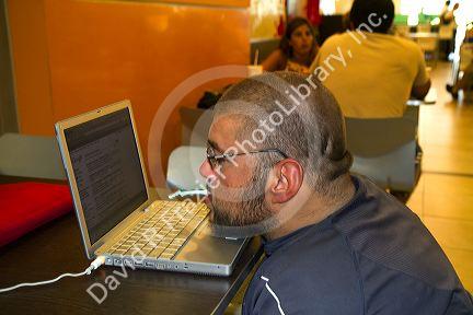 Quadriplegic Argentine man using a computer by typing with his mouth in Buenos Aires, Argentina.