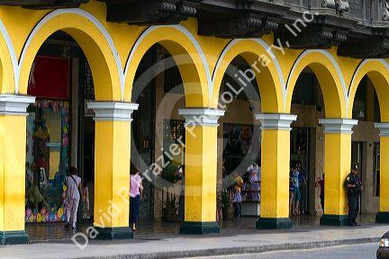 Yellow porticos lead to the entrance of the Plaza Mayor or Plaza de Armas of Lima, Peru.