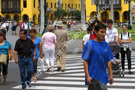 Pedestrians at the Plaza Mayor or Plaza de Armas of Lima, Peru.