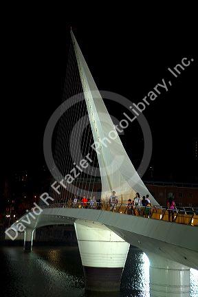 The Puente de la Mujer footbridge at night in the Puerto Madero district of Buenos Aires, Argentina.
