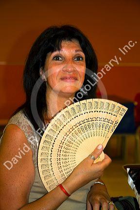 Argentine woman holding a fan in Buenos Aires; Argentina.