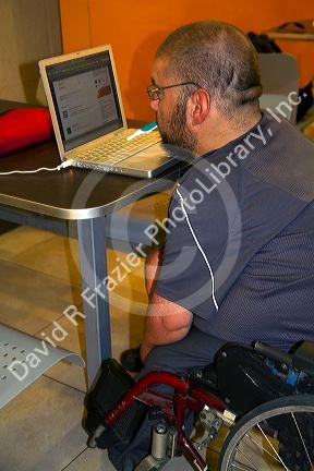 Quadriplegic Argentine man using a computer by typing with his mouth in Buenos Aires, Argentina.