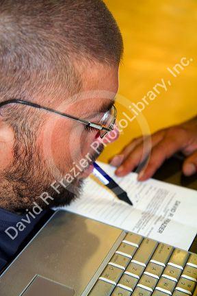 Quadriplegic Argentine man signing his name with his mouth in Buenos Aires, Argentina.