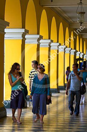 Yellow porticos lead to the entrance of the Plaza Mayor or Plaza de Armas of Lima, Peru.
