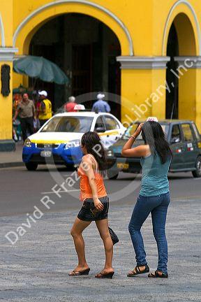 Pedestrians at the Plaza Mayor or Plaza de Armas of Lima, Peru.