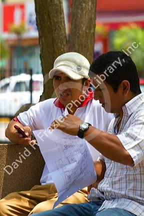Men having a meeting in Central Park of the Miraflores district of Lima, Peru.
