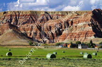 Red rock cliffs and newly harvested alfalfa hay near Dubois, Wyoming, USA.