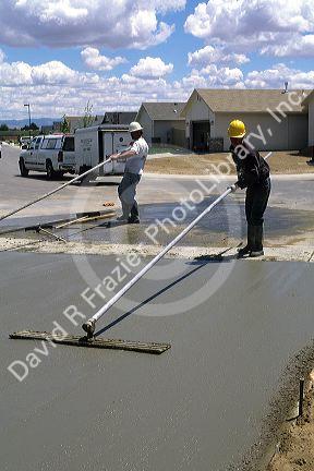 Workers floating a concrete slab.