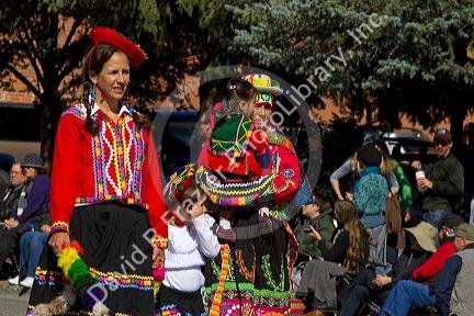 Peruvian people in traditional dress take part in the Trailing of the Sheep Parade on Main Street in Ketchum, Idaho, USA.