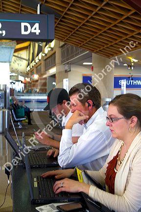 People use wi-fi internet at the Phoenix Sky Harbor International Airport located in the city of Phoenix, Arizona, USA.