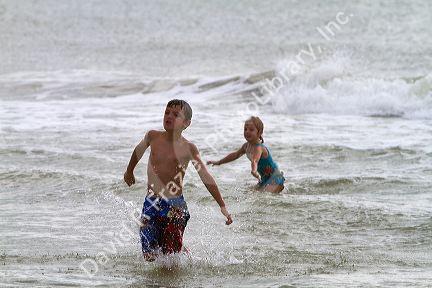 Brother and sister playing at Madeira Beach in Pinellas County, Florida, USA.