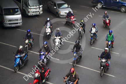 A group of scooters in traffic, Bangkok, Thailand.