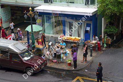 Street vendor selling food on a street corner in Bangkok, Thailand.