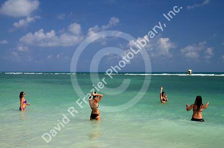 Women play volleyball in the Gulf of Thailand at Chaweng beach on the island of Ko Samui, Thailand.