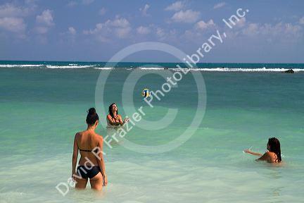 Women play volleyball in the Gulf of Thailand at Chaweng beach on the island of Ko Samui, Thailand.