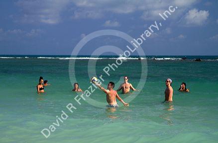 People play volleyball in the Gulf of Thailand at Chaweng beach on the island of Ko Samui, Thailand.
