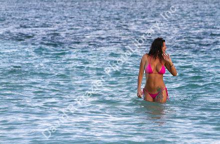 Woman wearing a bikini at Chaweng beach in the Gulf of Thailand on the island of Ko Samui, Thailand.