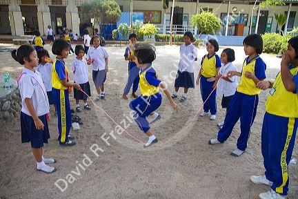 Thai elementary school students jump rope on the island of Ko Samui, Thailand.