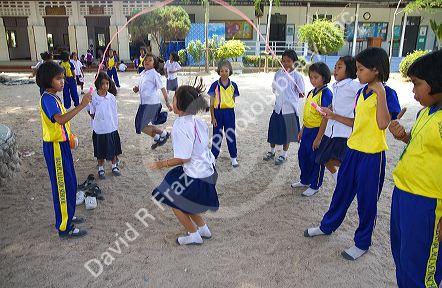 Thai elementary school students jump rope on the island of Ko Samui, Thailand.