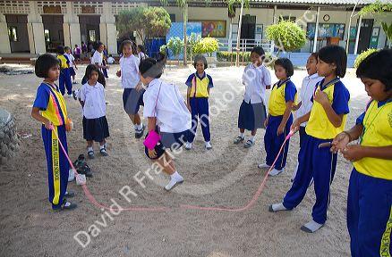 Thai elementary school students jump rope on the island of Ko Samui, Thailand.