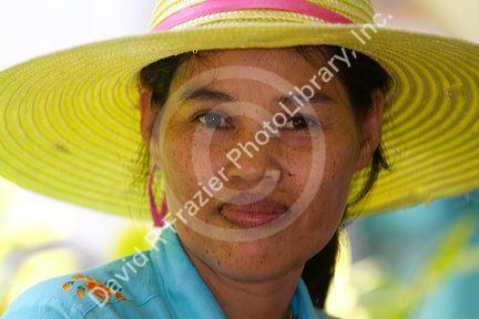 Portrait of a Thai woman wearing a hat at Chaweng beach on the island of Ko Samui, Thailand.