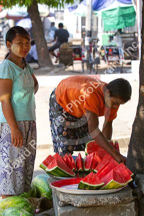 Street vendor selling sliced watermelon in (Rangoon) Yangon, (Burma) Myanmar.