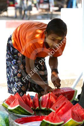 Street vendor selling sliced watermelon in (Rangoon) Yangon, (Burma) Myanmar.