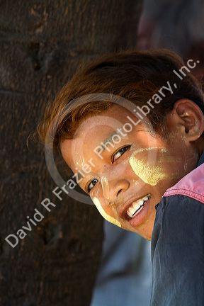 Portrait of a Burmese boy wearing thanaka on his cheeks in (Rangoon) Yangon, (Burma) Myanmar.