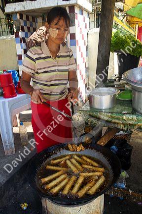 Street food vendor selling eggrolls in (Rangoon) Yangon, (Burma) Myanmar.