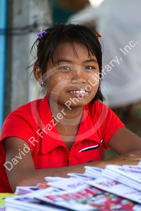 Burmese girl selling newspapers in (Rangoon) Yangon, (Burma) Myanmar.