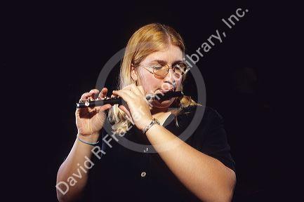 A girl playing a piccolo.