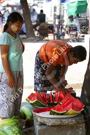 Street vendor selling sliced watermelon in (Rangoon) Yangon, (Burma) Myanmar.