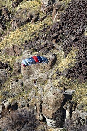 A BASE jumper parachuting from the I.B. Perrine Bridge spanning the Snake River canyon at Twin Falls, Idaho, USA.