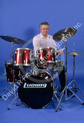A man playing a set of drums.