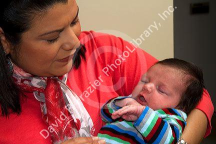 Hispanic mother holding her infant son in Boise, Idaho, USA. MR