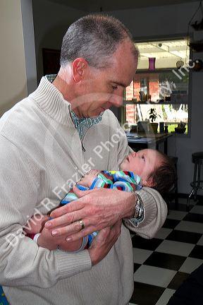 Father holding his infant son in Boise, Idaho, USA. MR