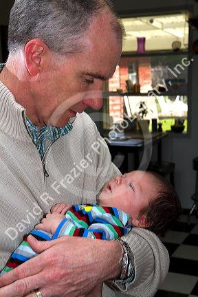 Father holding his infant son in Boise, Idaho, USA. MR
