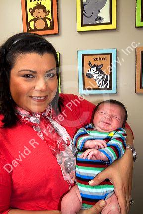 Hispanic mother holding her infant son in Boise, Idaho, USA. MR