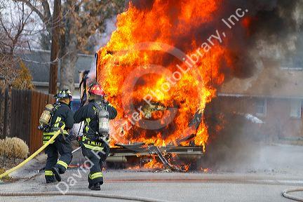 Firefighers putting out a motor home on fire in Boise, Idaho, USA.