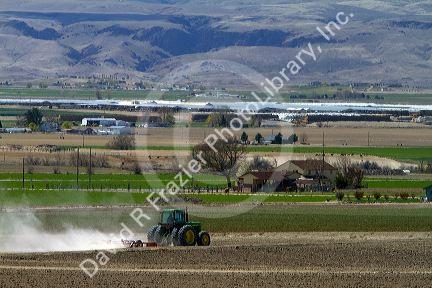 Tractor being used for spring tilling in Canyon County, Idaho, USA