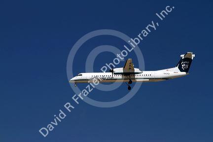 Alaska airlines Bombardier Q400 commuter airplane in flight.