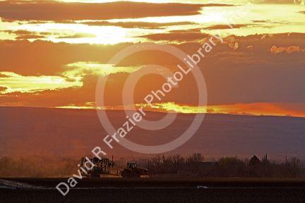 Tracked tractor at sunset in Canyon County, Idaho, USA.