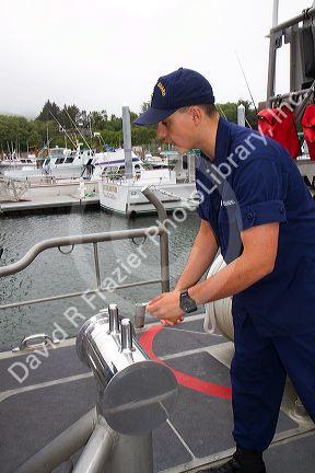 Coast Guard petty officer on a resue boat at Newport, Oregon, USA.